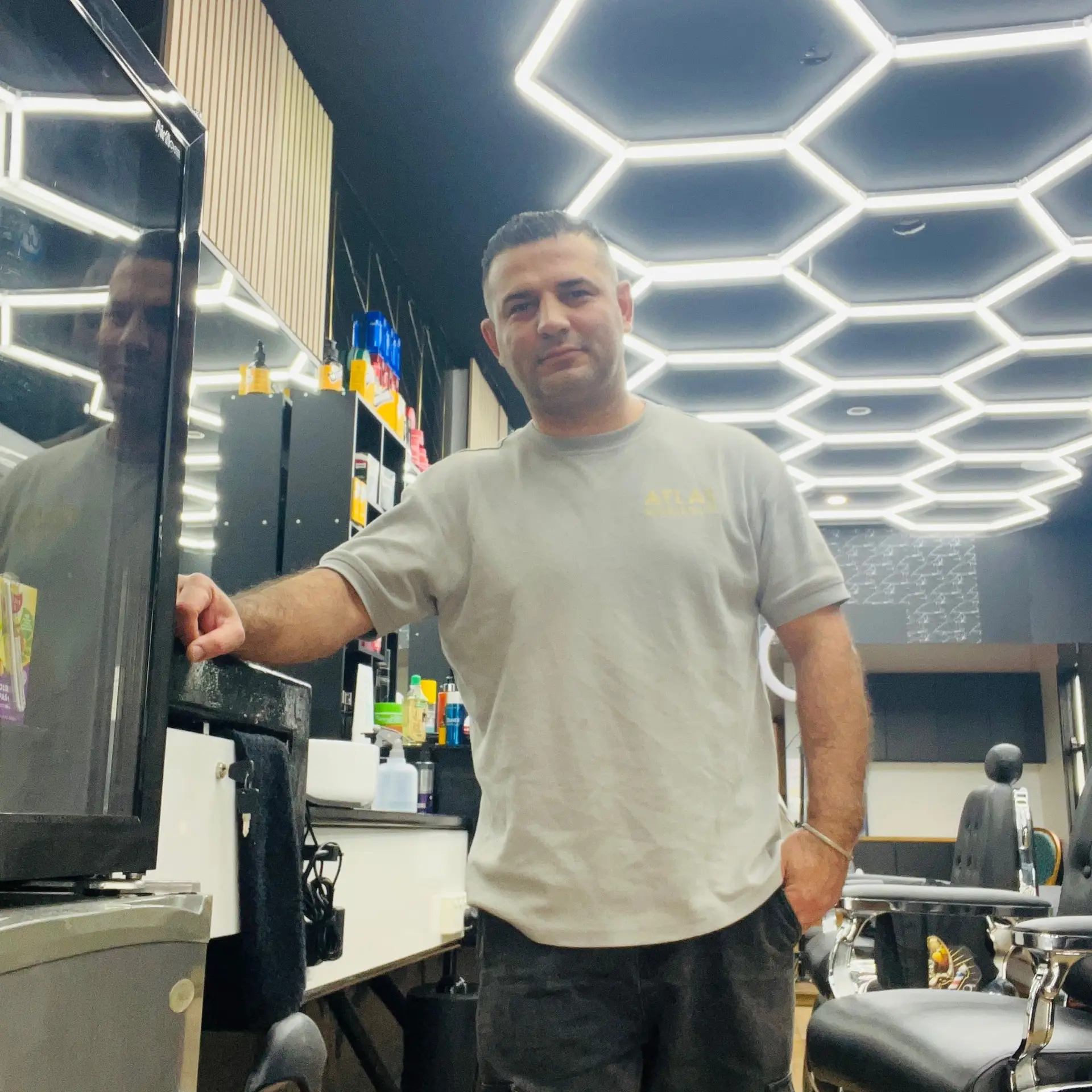 Mack at his barber station in Atlas Barbershop