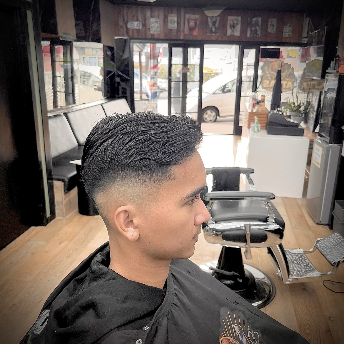 Textured mid skin fade finished at Atlas Barbershop